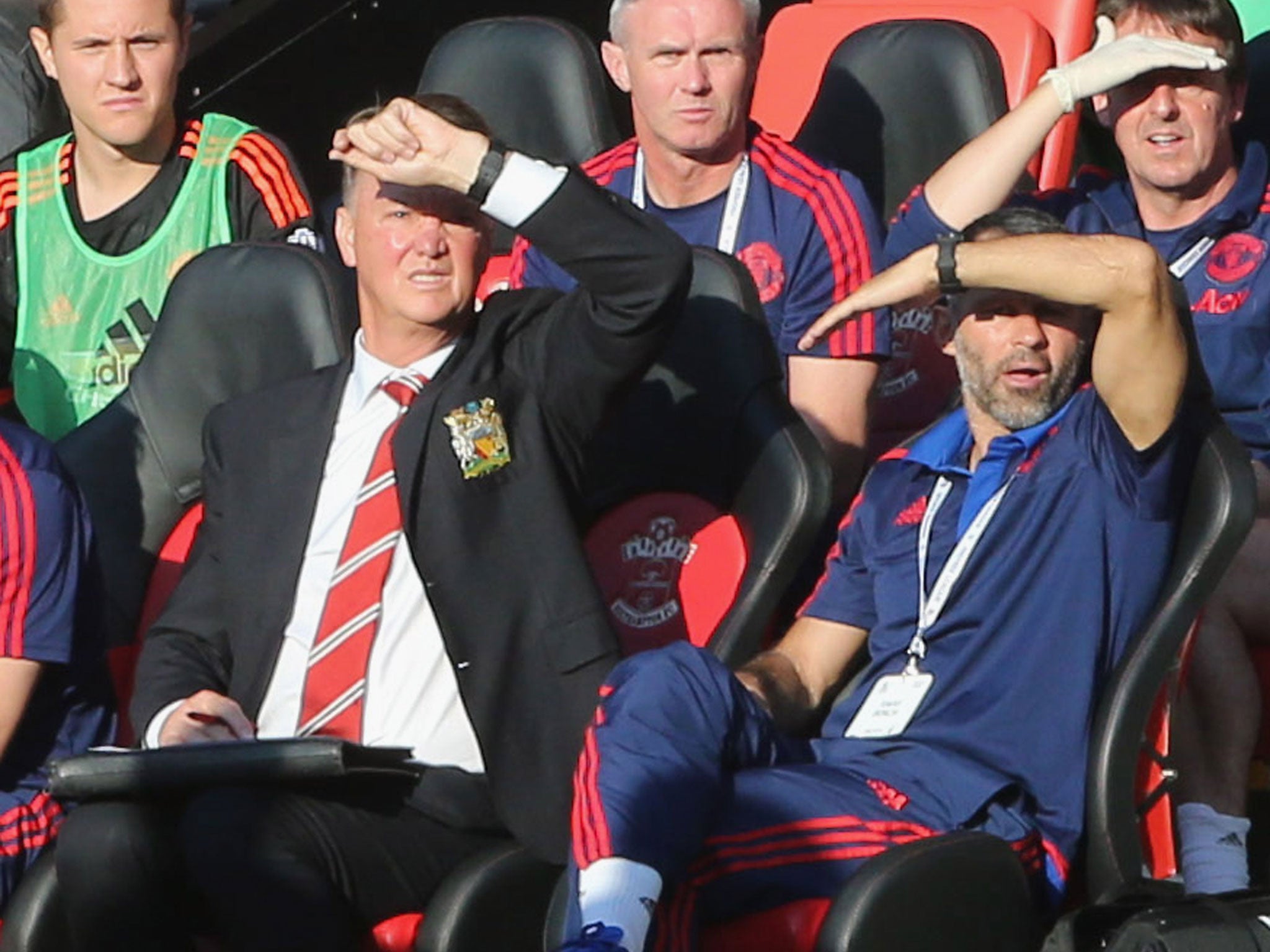 Louis van Gaal and assistant manager Ryan Giggs shield their eyes from the sun