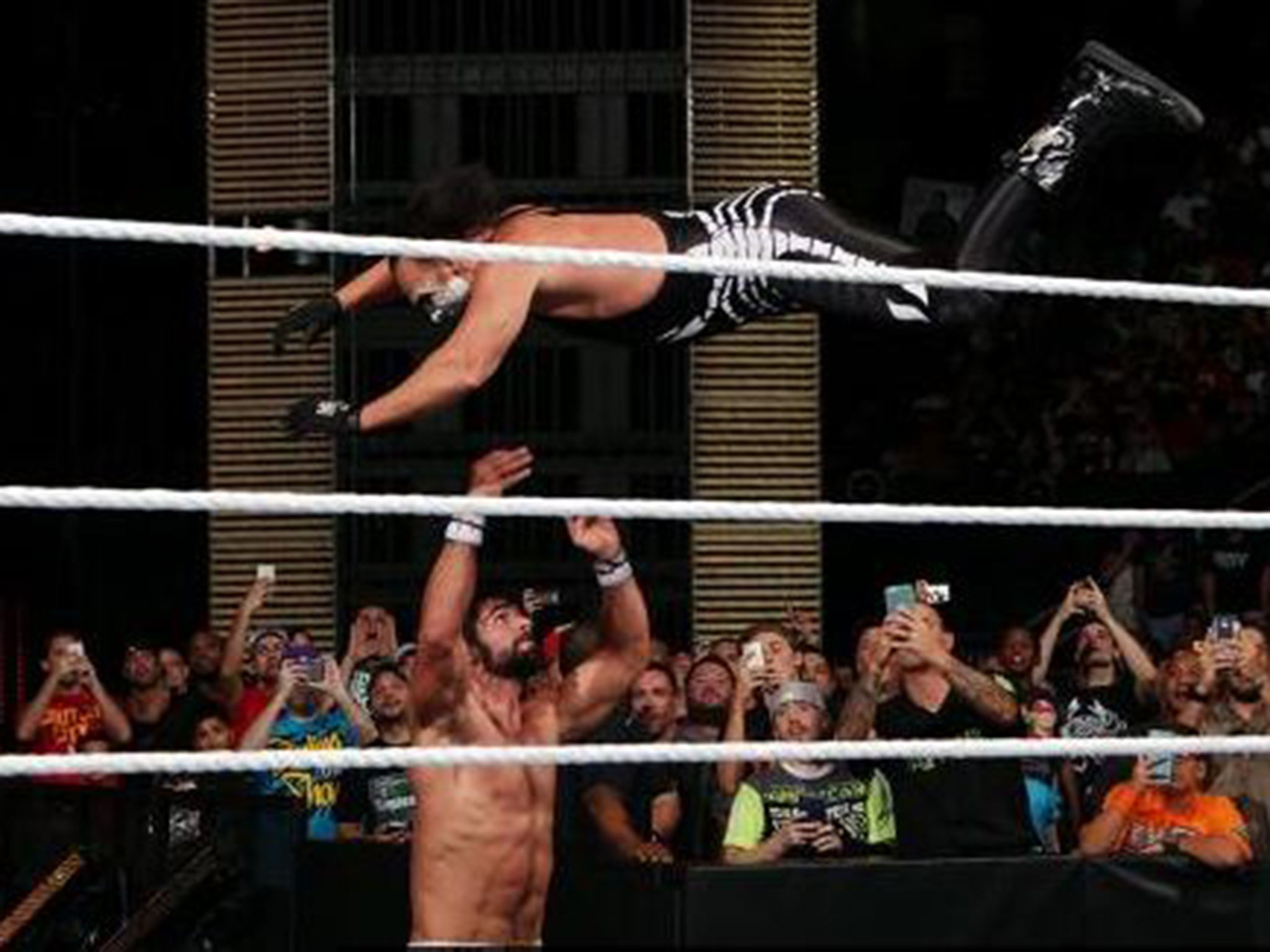 Sting flies through the air against Seth Rollins