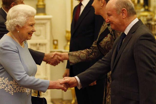 Walker with the Queen at Buckingham Palace: he developed a reputation as a much respected adviser