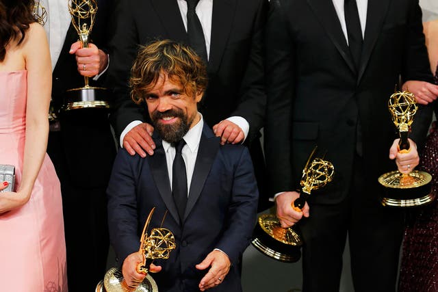 Actor Peter Dinklage and the cast of HBO's "Game of Thrones" pose backstage with their Outstanding Drama Series award during the 67th Primetime Emmy Awards in Los Angeles, California
