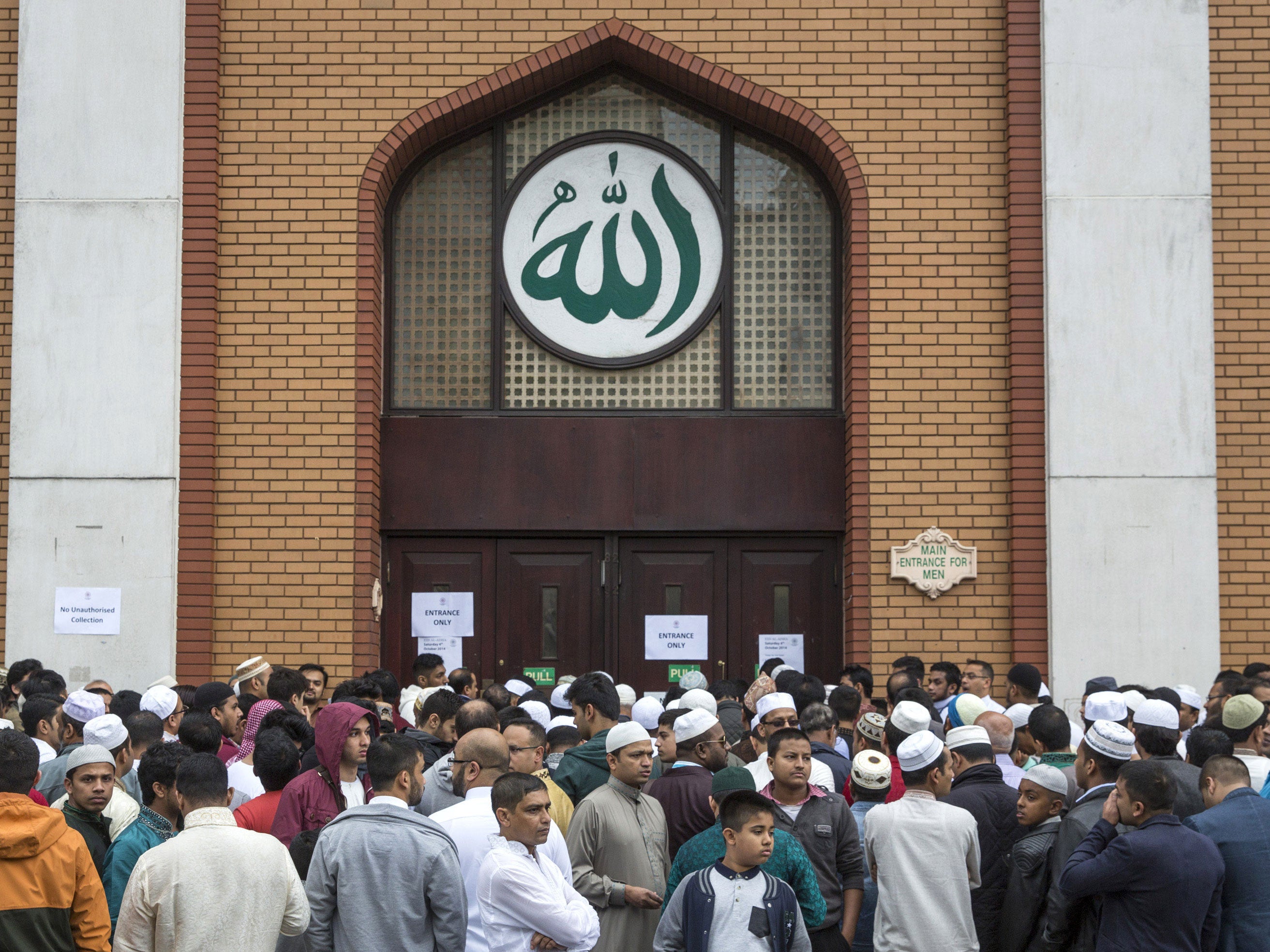 Men wait to enter the East London Mosque on Eid al-Adha 2014