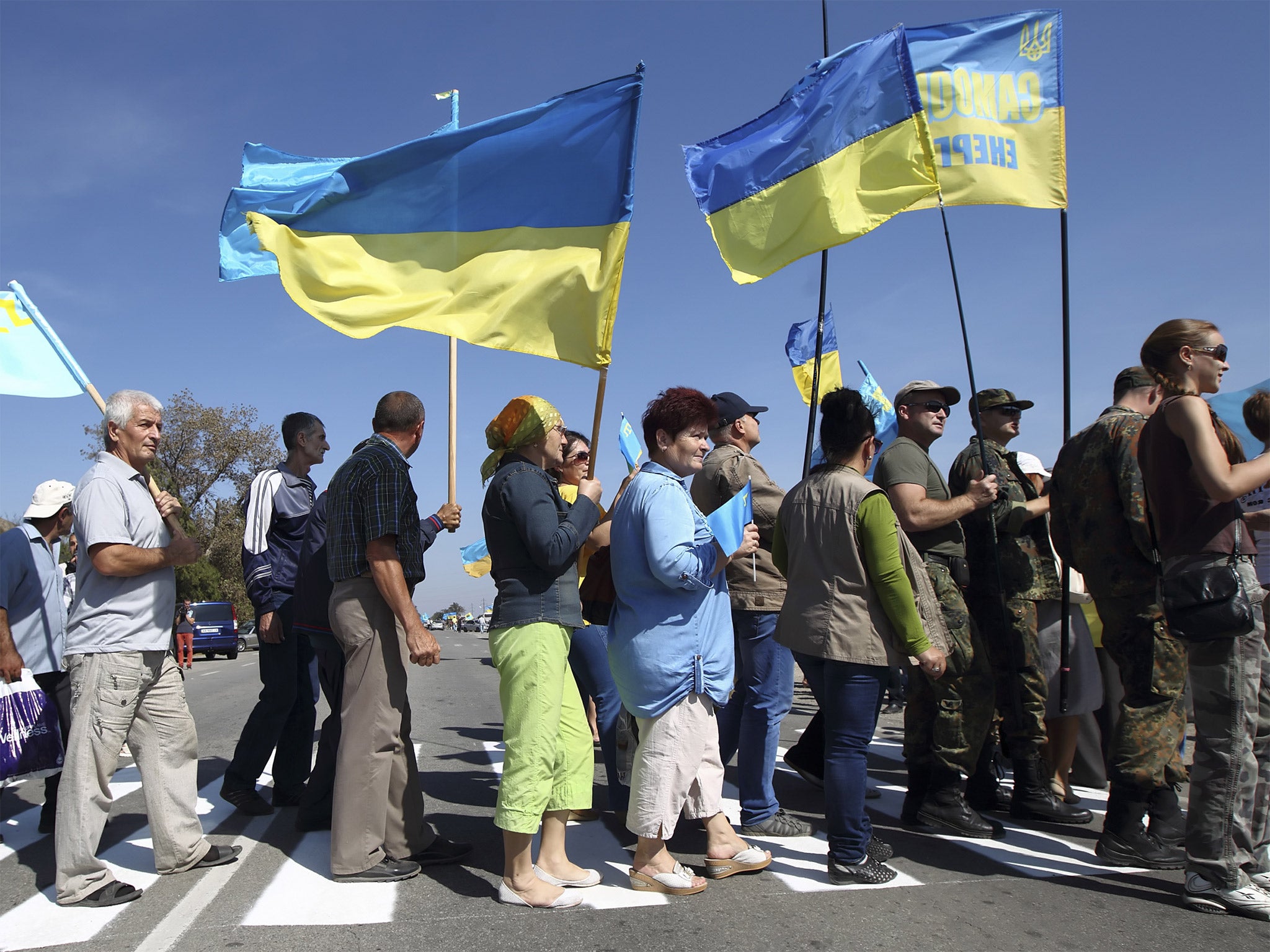 Crimean Tatars and Ukrainian activists block the road at a checkpoint near the border between Ukraine and Crimea