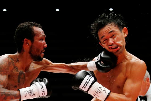 Japanese champion Shinsuke Yamanaka, right, gets a punch from Panama's challenger Anselmo Moreno in the eighth round of their WBC bantamweight boxing title match in Tokyo, Japan. Yamanaka defended his title by a 2-1 decision