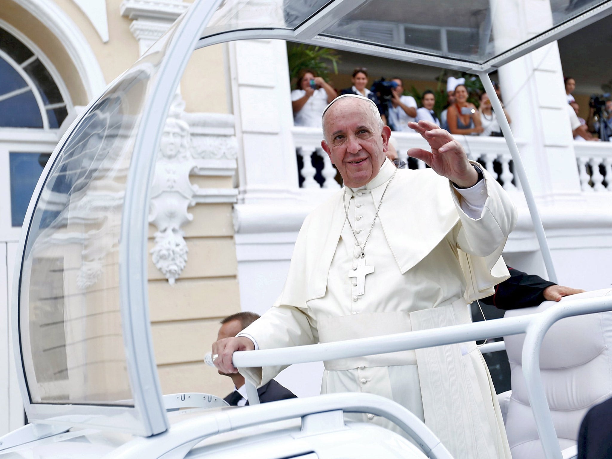 Pope Francis waves to supporters in Santiago de Cuba on Tuesday