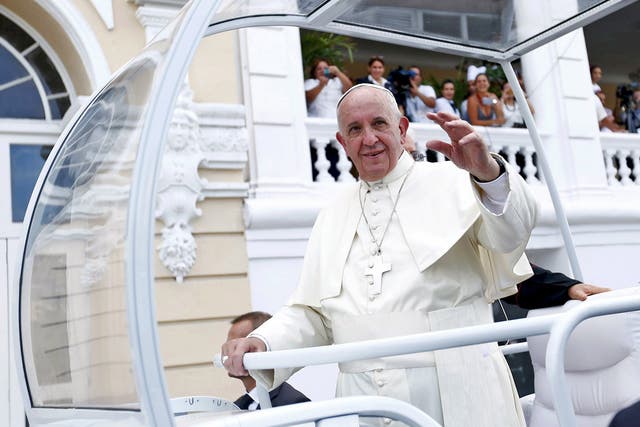 Pope Francis waves to supporters in Santiago de Cuba on Tuesday