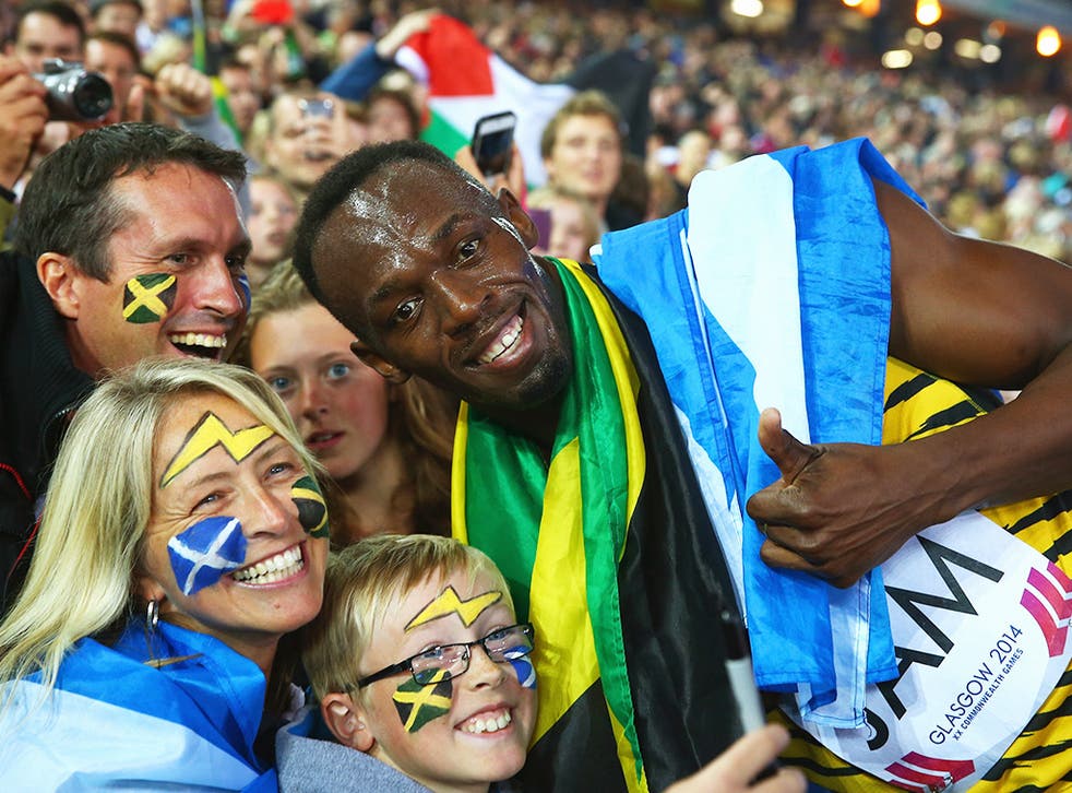 Usain Bolt celebrates with supporters after Jamaica won 4x100m relay gold