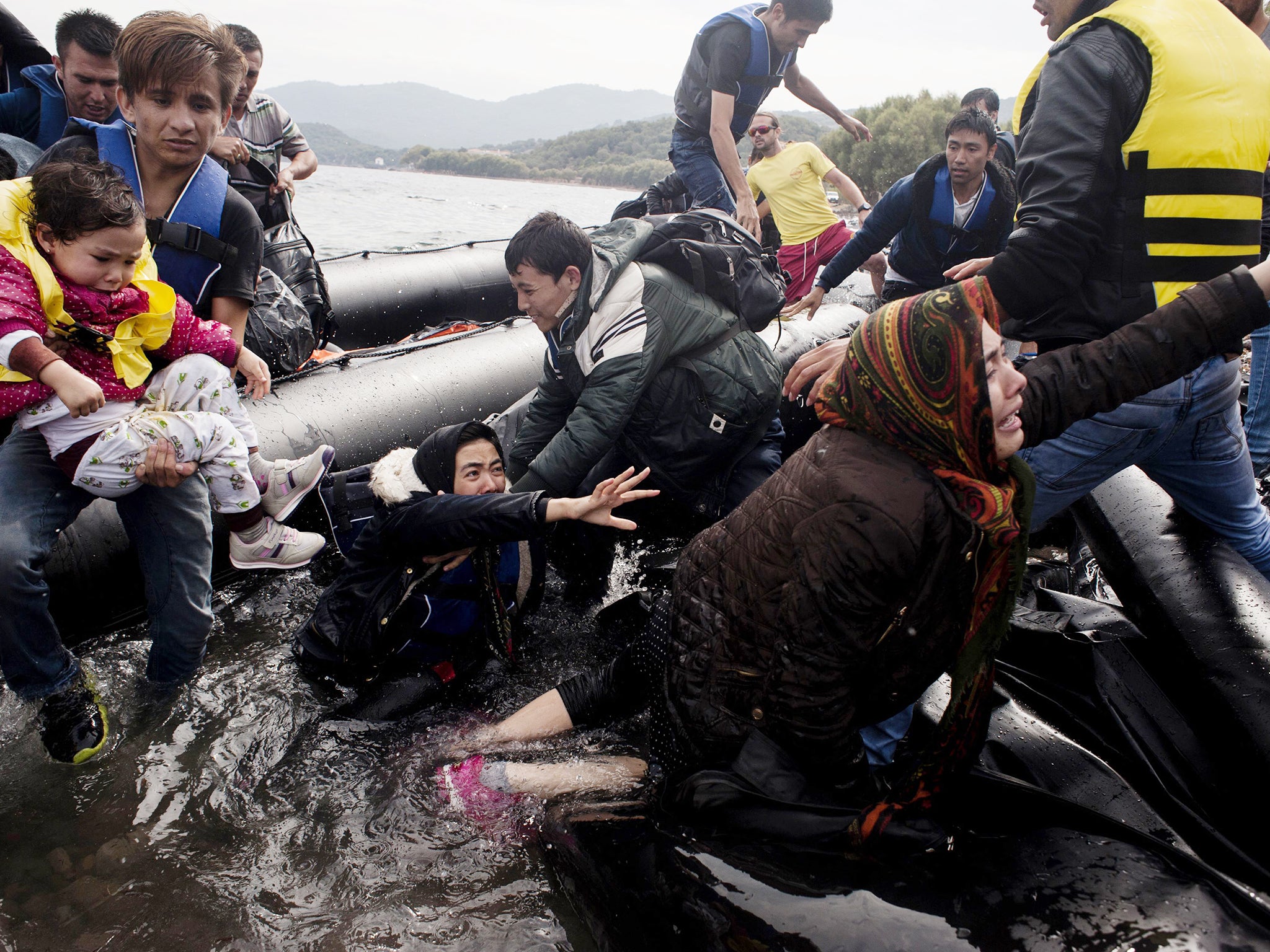 Refugees arrive on Sykamia beach, west of the port of Mytilene, on the Greek island of Lesbos