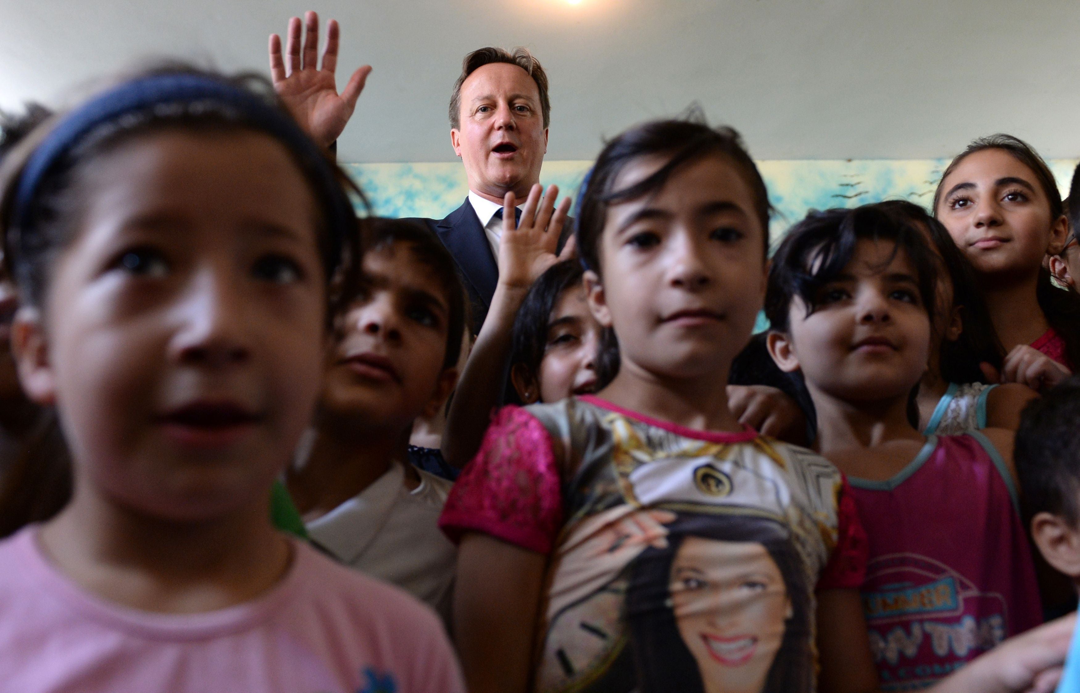 David Cameron on a visit to a school in Beirut, Lebanon, where many Syrian refugees have fled to (PA)