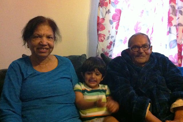 The Sharmas pictured with one of their grandchildren