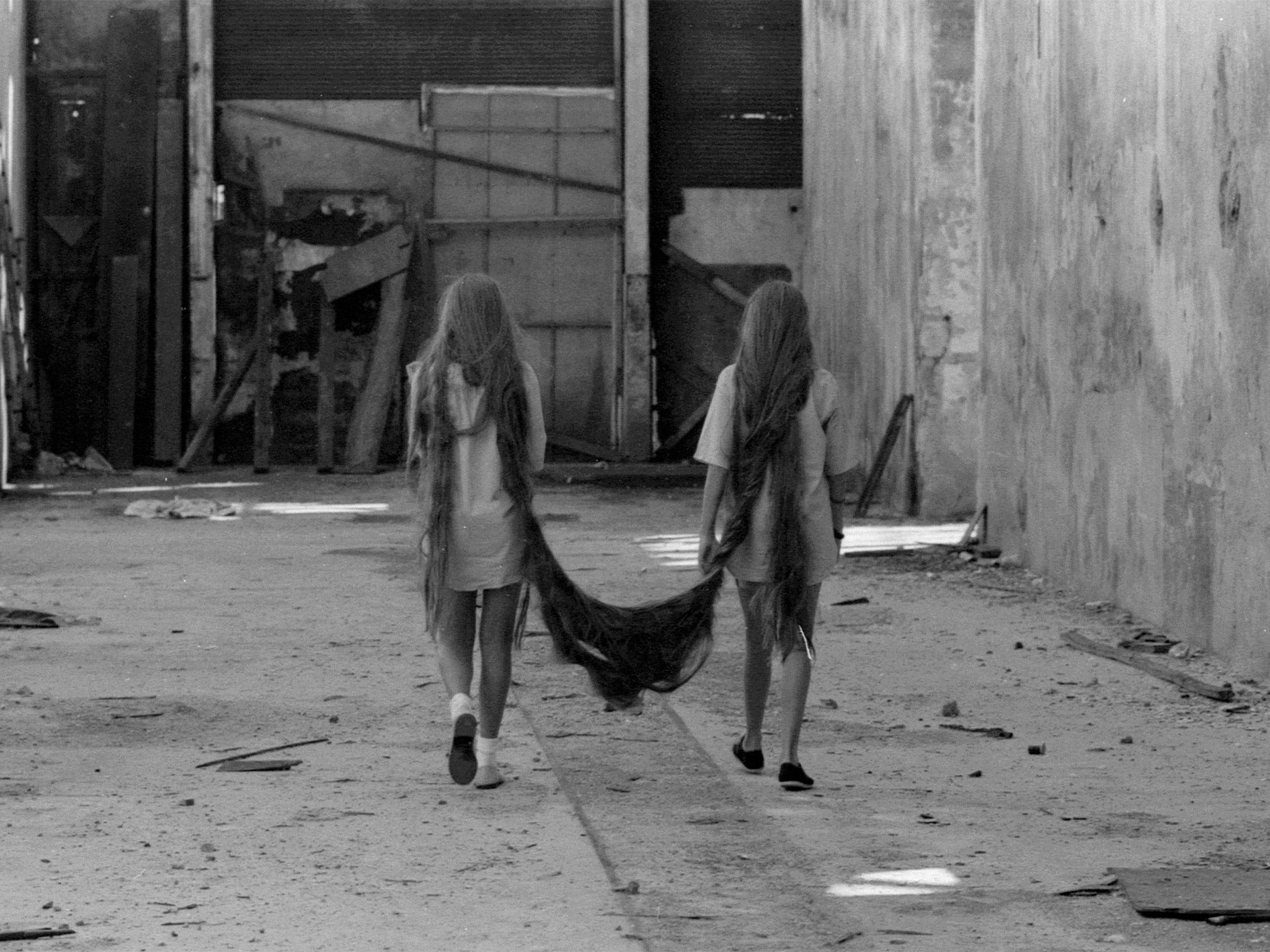 One of the eerie 1984 photographs documenting Tunga’s art work ‘Siamese Hair Twins’