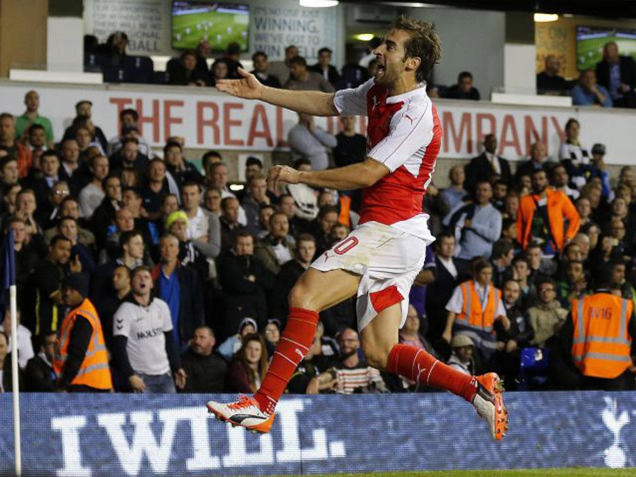 Flamini celebrates scoring the winner against Arsenal's old rivals