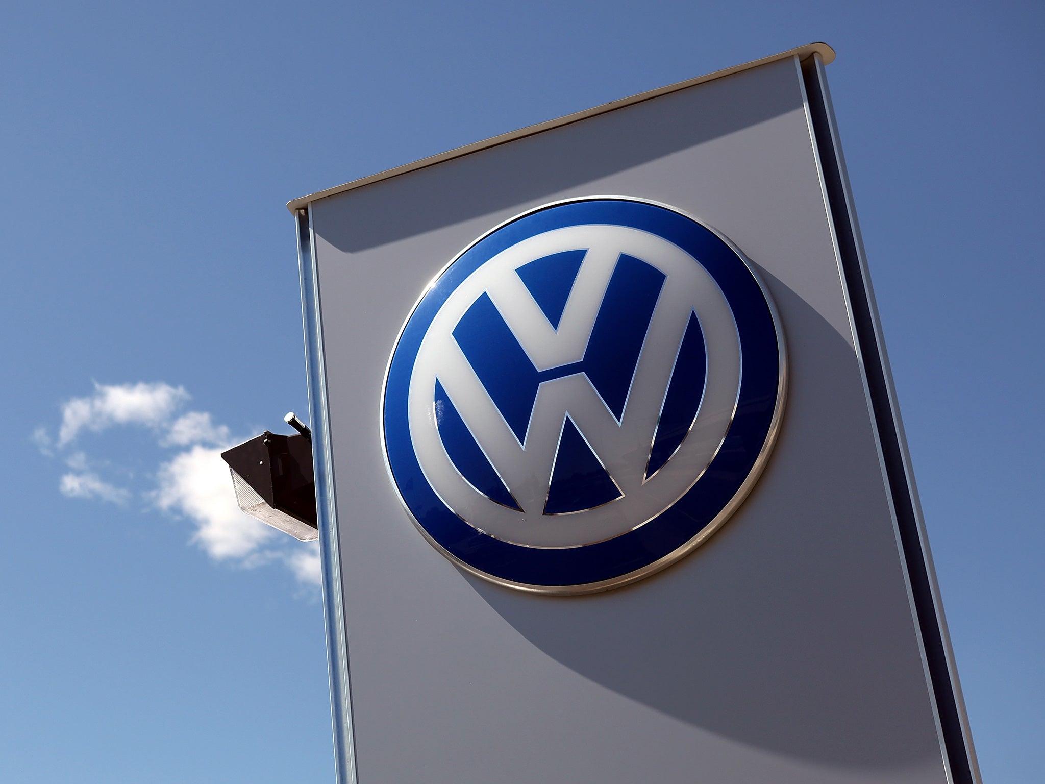 A logo is displayed on a sign in front of a Volkswagen dealership on March 28, 2011 in San Rafael, California