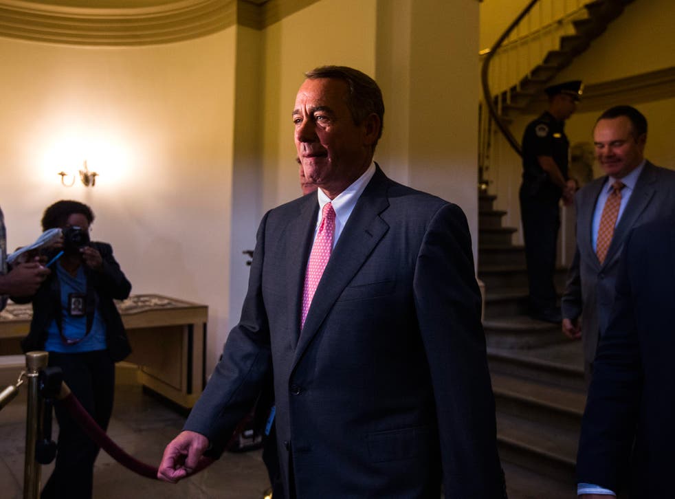 John Boehner walks through the hallways of the U.S. Capitol to a press conference at which he announced his resignation 