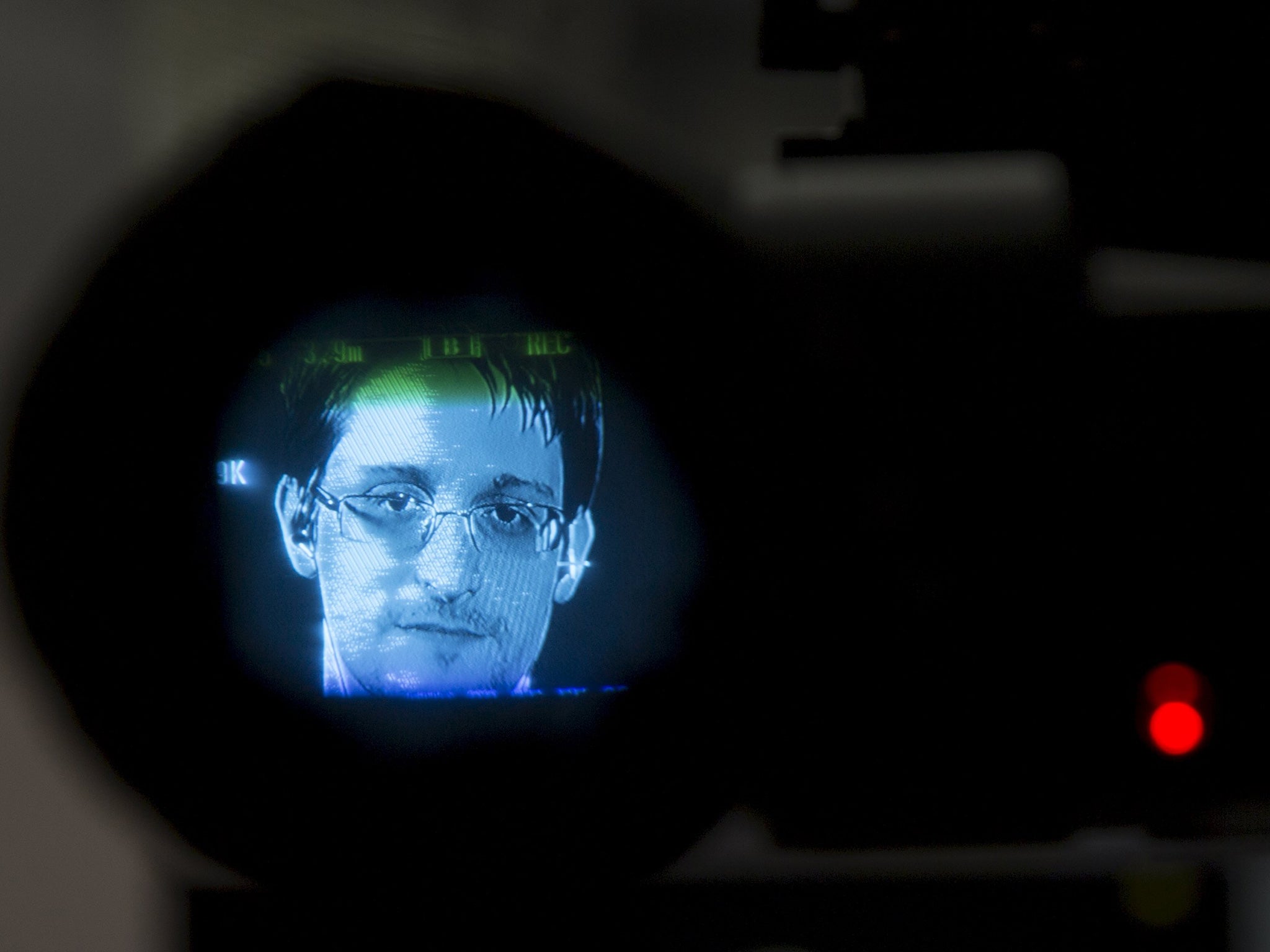 Edward Snowden is seen through a camera viewfinder as he delivers remarks via video link from Moscow to attendees at a discussion regarding an International Treaty on the Right to Privacy