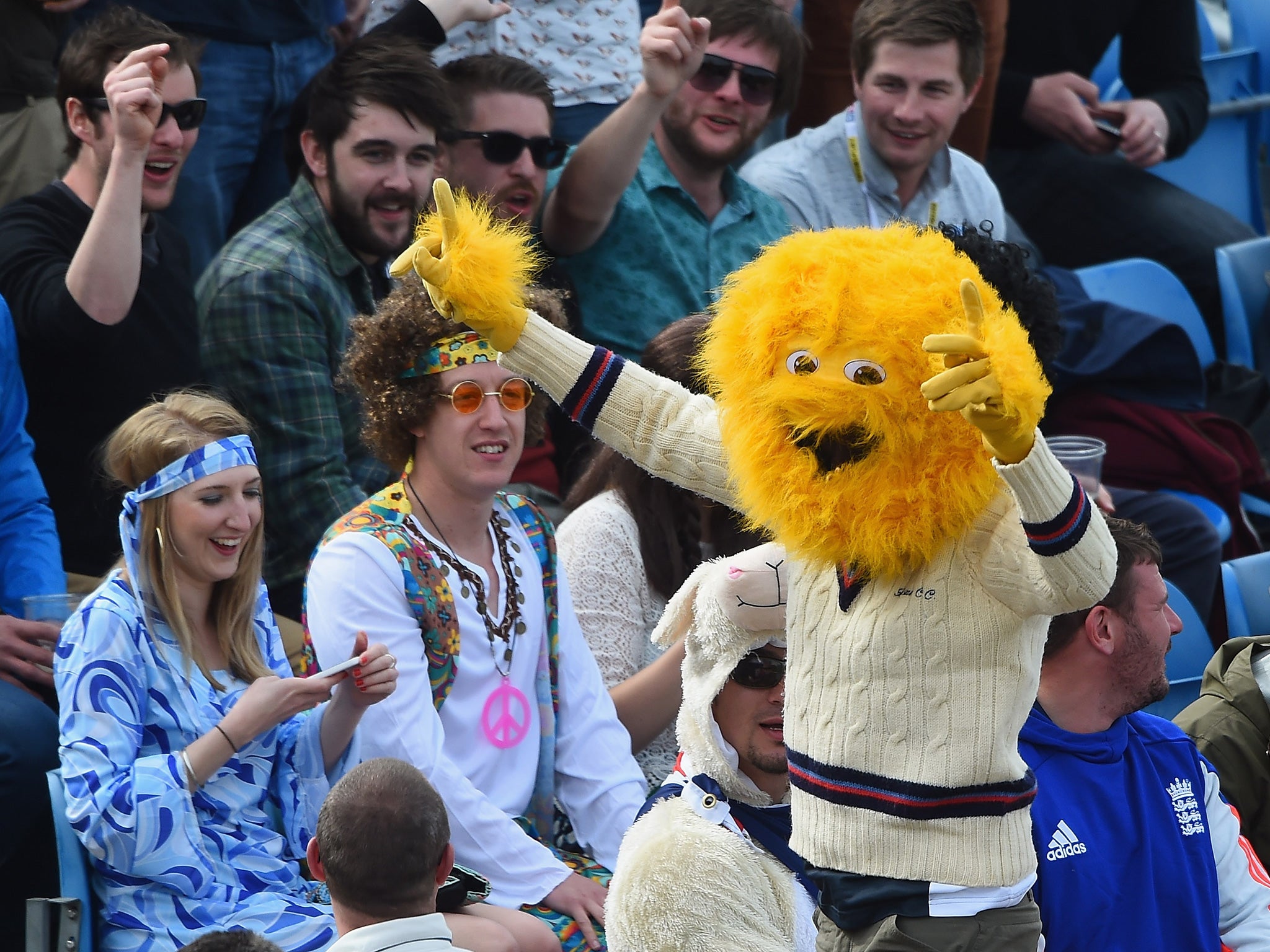 A cricket fan dons the Honey Monster’s head, much to the amusement of a couple of hippies at Headingley earlier this summer. Meanwhile, in the background, a Test match takes place