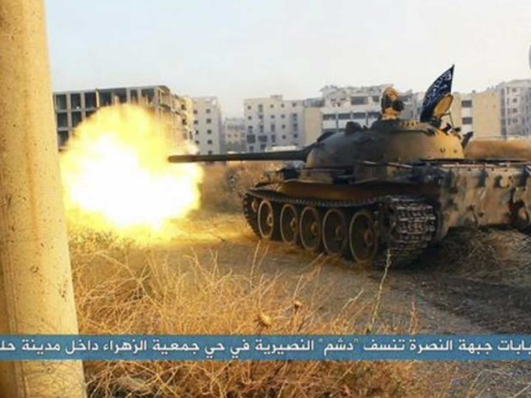 An al-Nusra Front tank fires during their clashes against the Syrian government forces, taken from Twitter account affiliated with the group