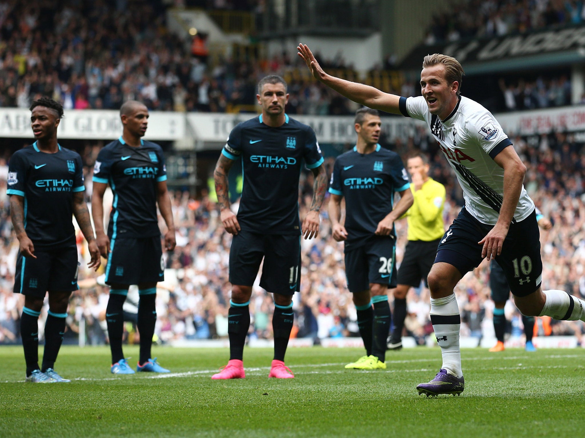 Harry Kane celebrates his goal as City players watch on