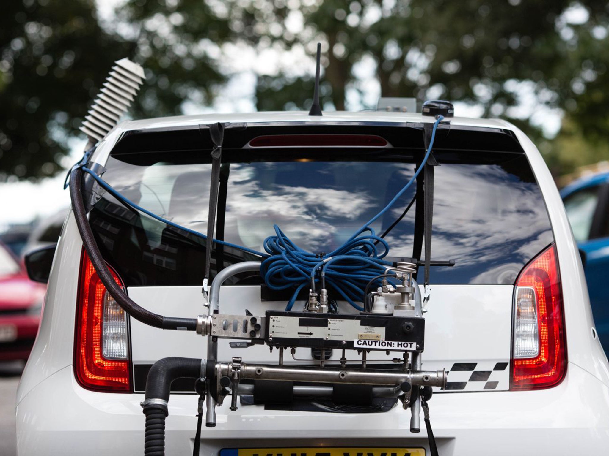 The equipment is mounted like a bike rack with a pipe fitted over the exhaust which leads into a black box that measures the fumes