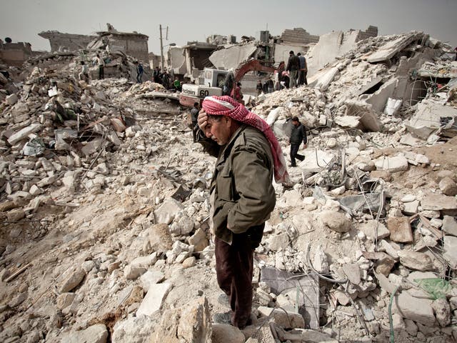 A Syrian man stands among the rubble of his house following one of the Syrian regime's devastating airstrikes on the city of Aleppo