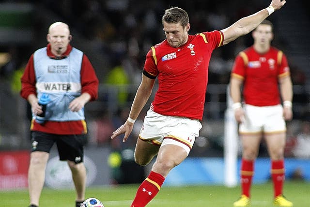 Dan BIggar kicks a penalty for Wales after yet another error by England