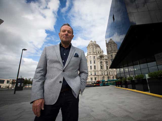 Former left-wing British politician, Derek Hatton, pictured in his home city of Liverpool, with the iconic Liver Building in the background.