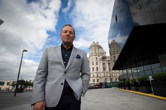 Former left-wing British politician, Derek Hatton, pictured in his home city of Liverpool, with the iconic Liver Building in the background.
