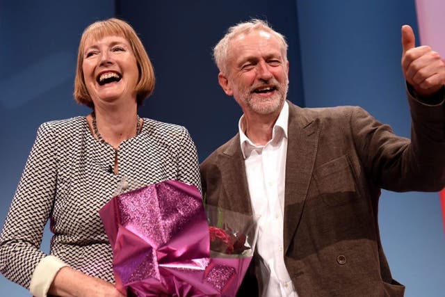 epa04952499 Former acting leader of the Labour party Harriet Harman (L) receives flowers from Leader of the British Labour Party leader Jeremy Corbyn at the Labour Conference in Brighton, Britain, 27 September 2015.  EPA/FACUNDO ARRIZABALAGA