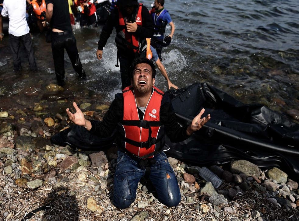 A refugee arrives at the Greek island of Lesbos