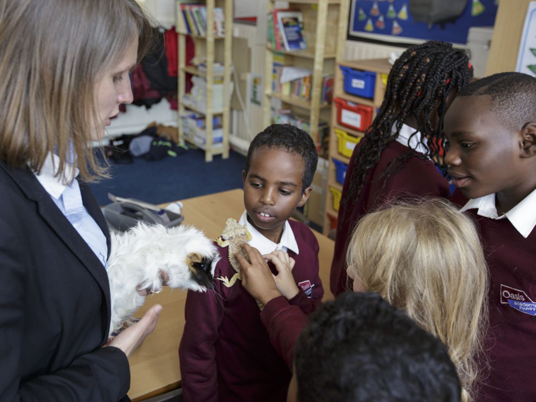 Emma Johnson with pupils at the Oasis Academy Foundry in Winson Green, Birmingham, who are encouraged to look after animals