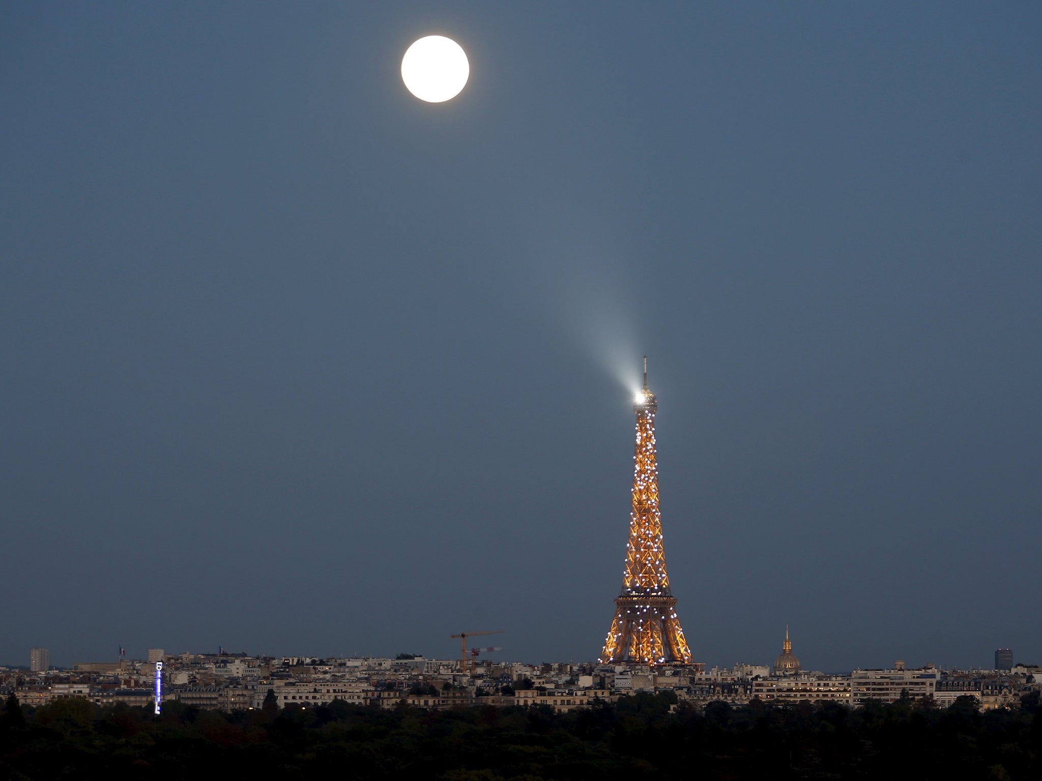 A super moon rises in the sky near the Eiffel tower as seen from Suresnes, Western Paris, France