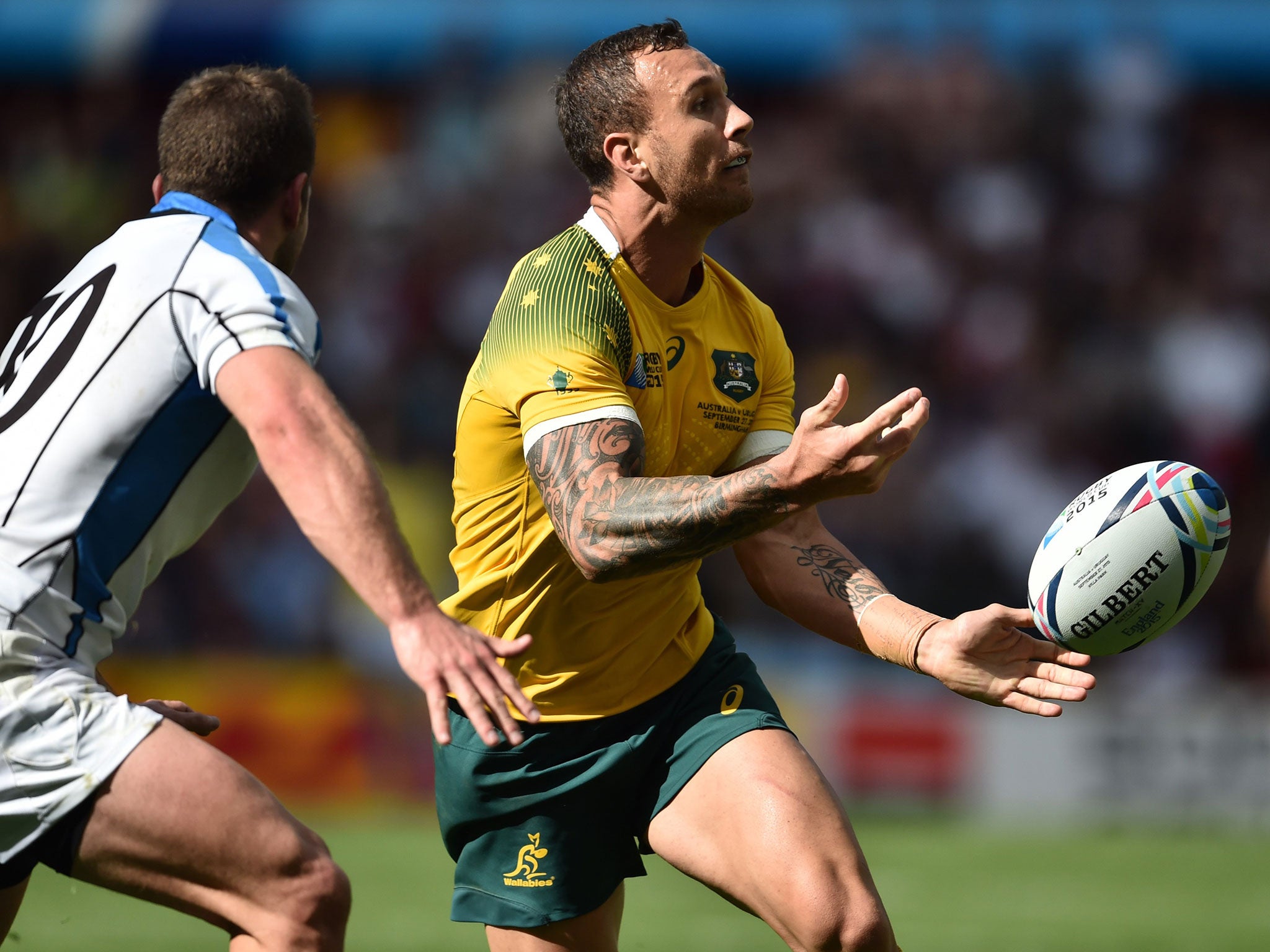 Quade Cooper passes the ball during Australia's win over Uruguay