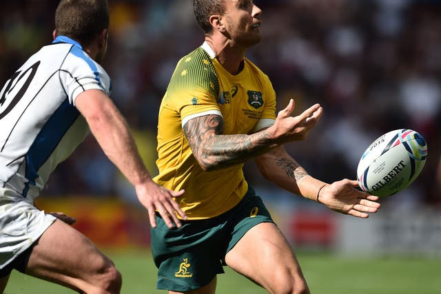 Quade Cooper passes the ball during Australia's win over Uruguay