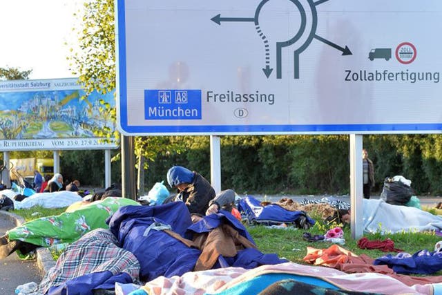 Refugees are forced to sleep outdoors at the Austrian-German border in Freilassing after Germany imposed immediate emergency border controls with Austria
