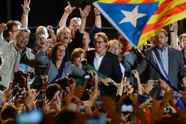 Jubilant leader of Junts Pel Sí Artur Mas, centre, celebrates with his supporters