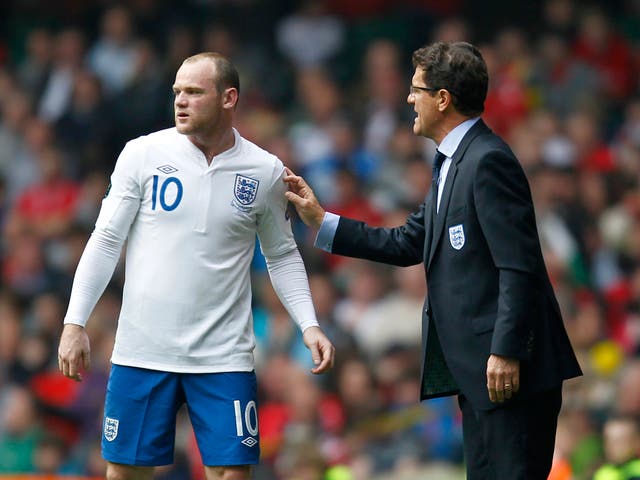 Italian manager Fabio Capello gives Wayne Rooney some instruction during a Euro 2012 qualifier against Wales