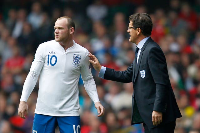 Italian manager Fabio Capello gives Wayne Rooney some instruction during a Euro 2012 qualifier against Wales