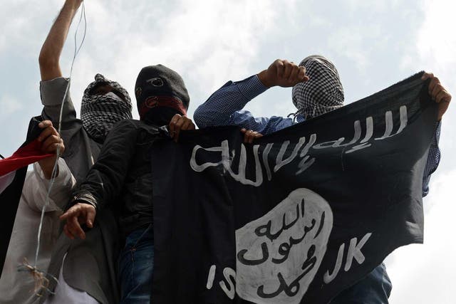 The Isis flag is held up by demonstrators