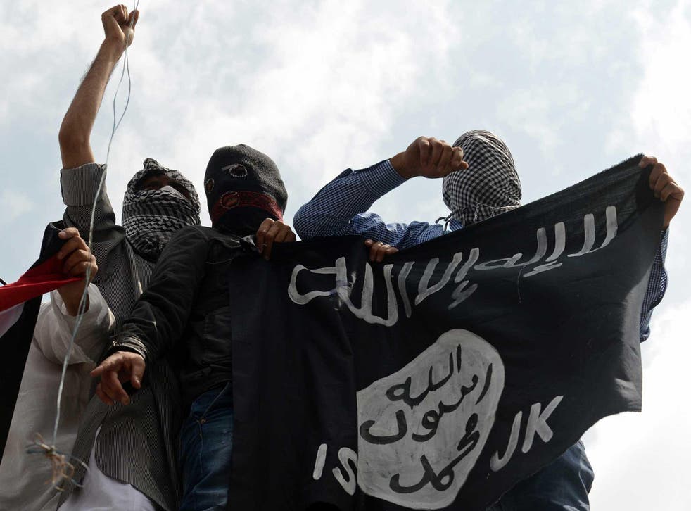 The Isis flag is held up by demonstrators