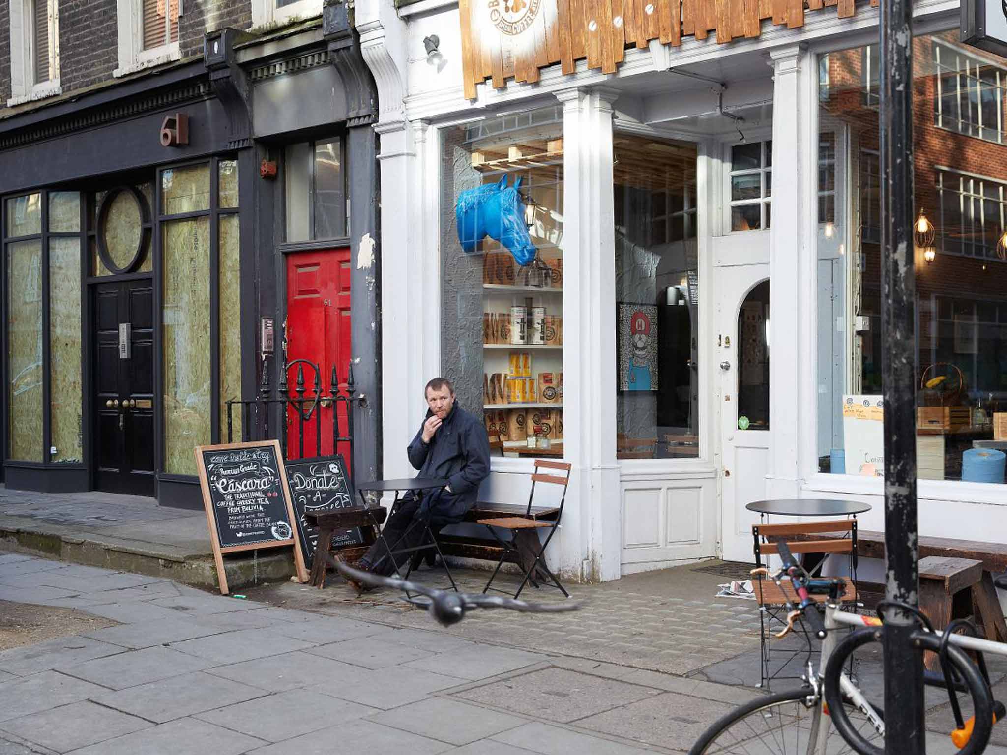 Guy Ritchie, waiting for a coffee at his local café in Fitzrovia