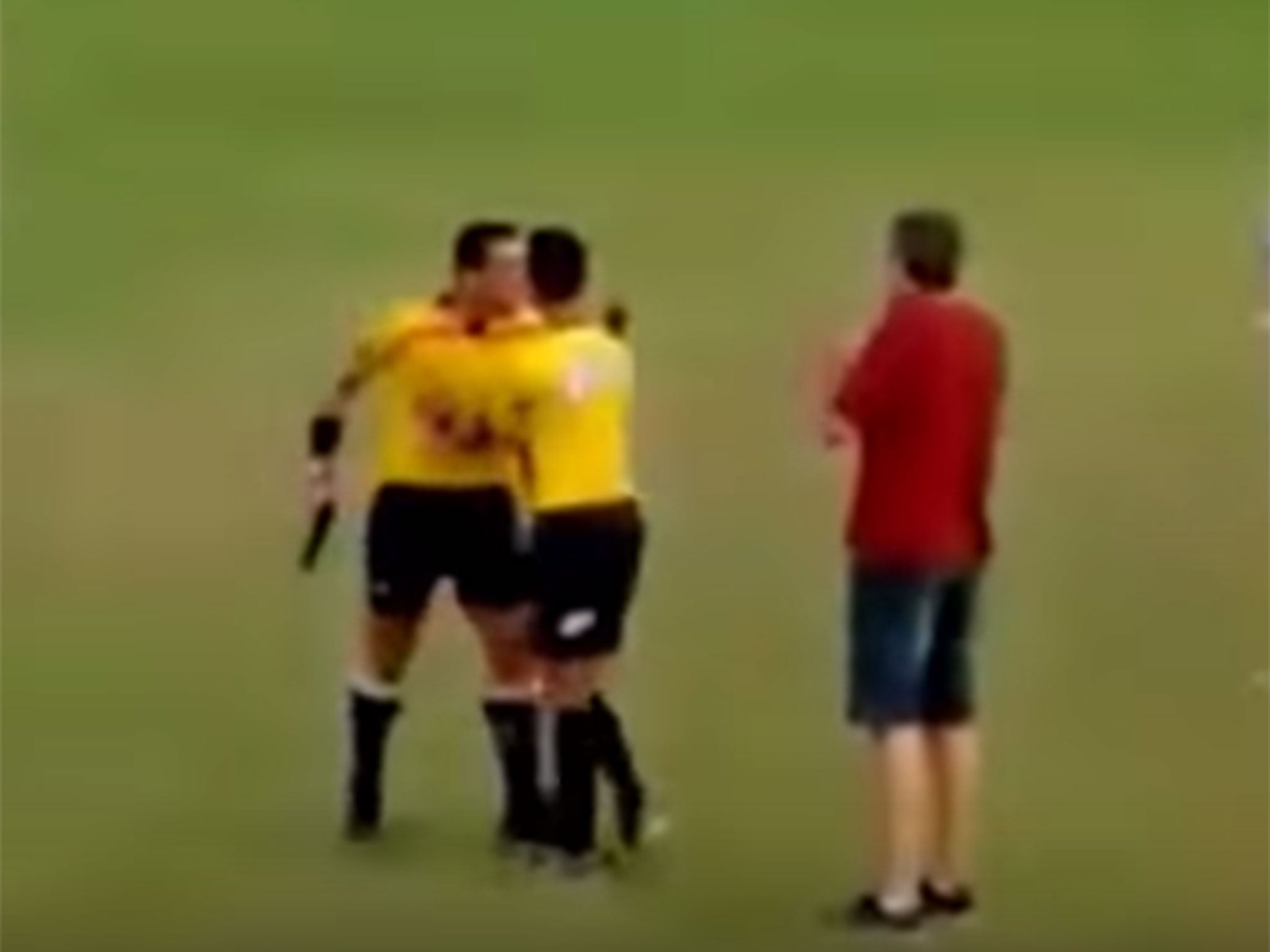 Referee Gabriel Murta pulls a gun during a match