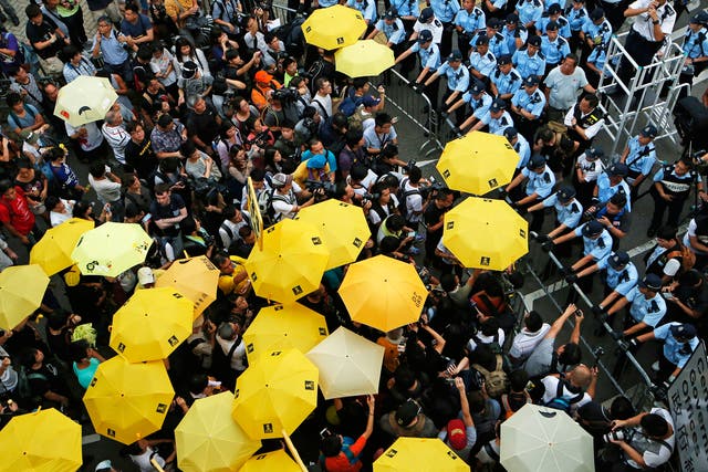 Protesters observe a moment of silence to mark the first anniversary of the ‘Umbrella Movement’ outside the government HQ in Hong Kong