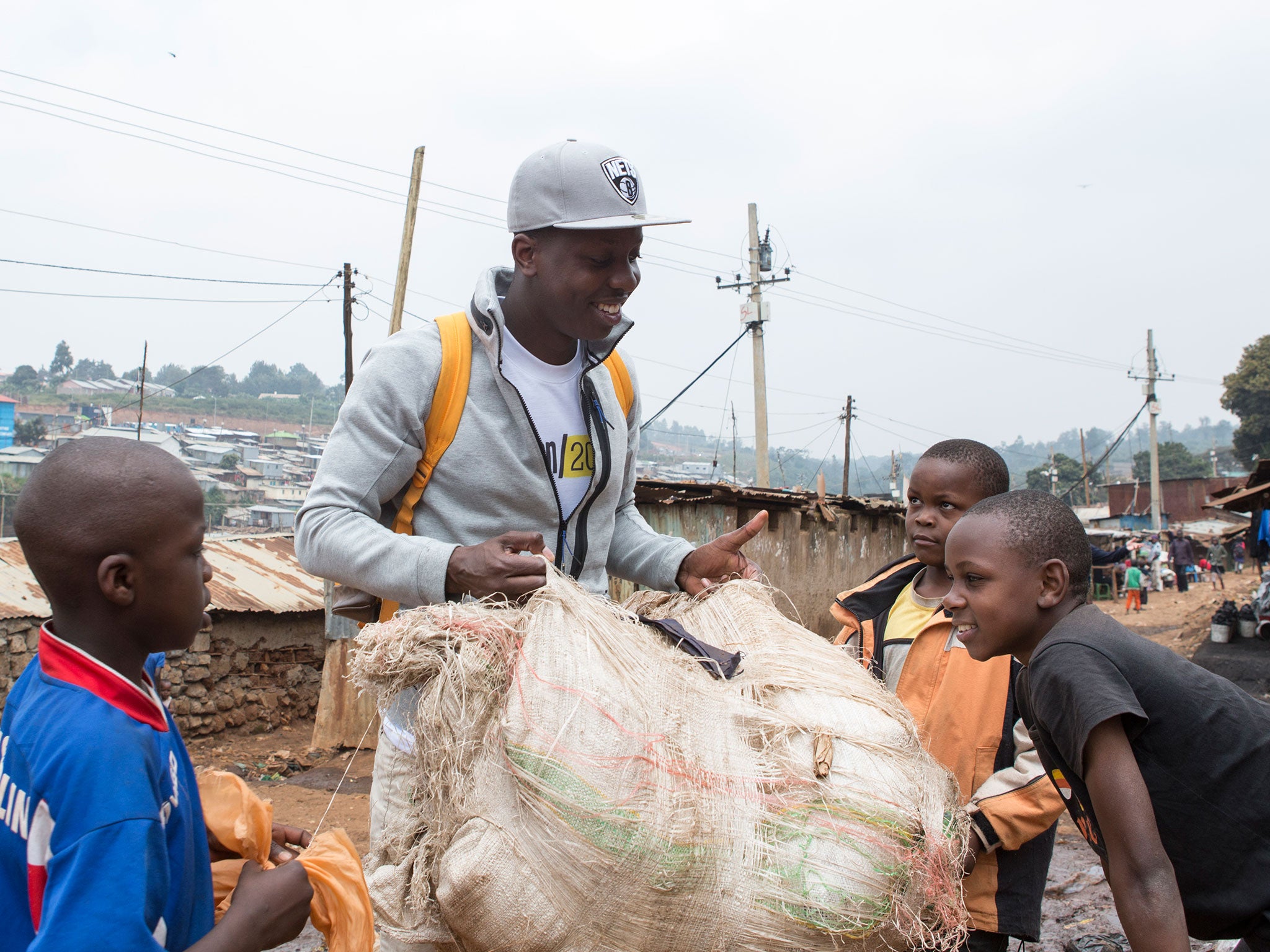 Jamal with children in Kibera, where unemployment is at 50 per cent and many residents live in extreme poverty