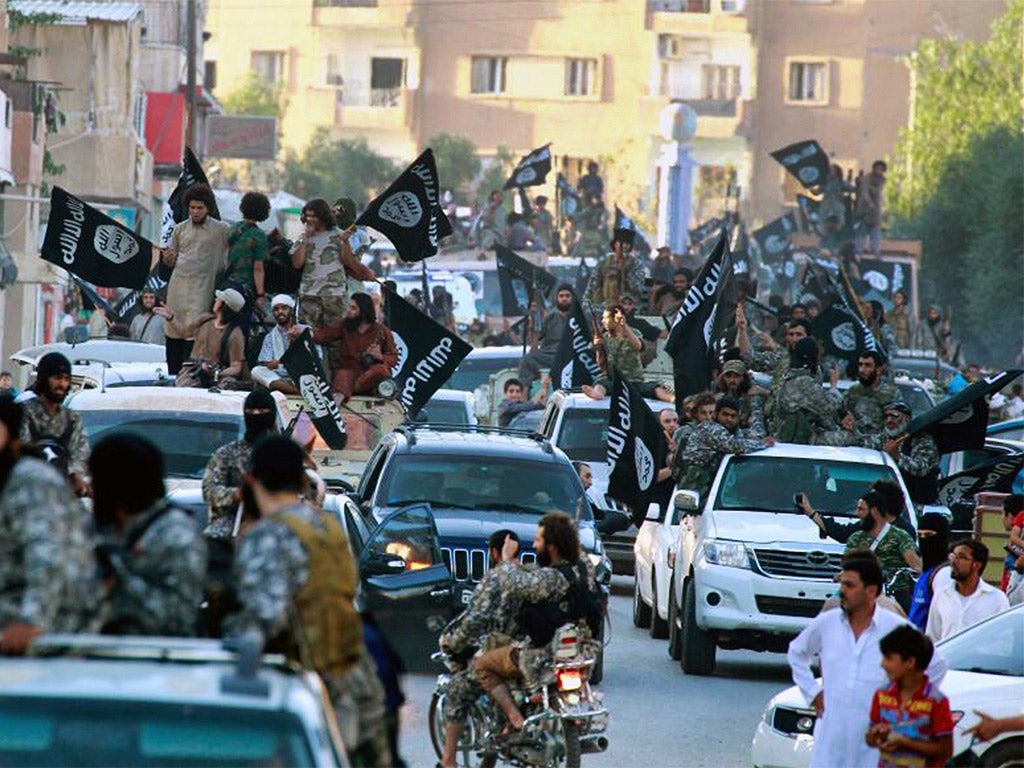 Isis troops parade through Raqqa in northern Syria