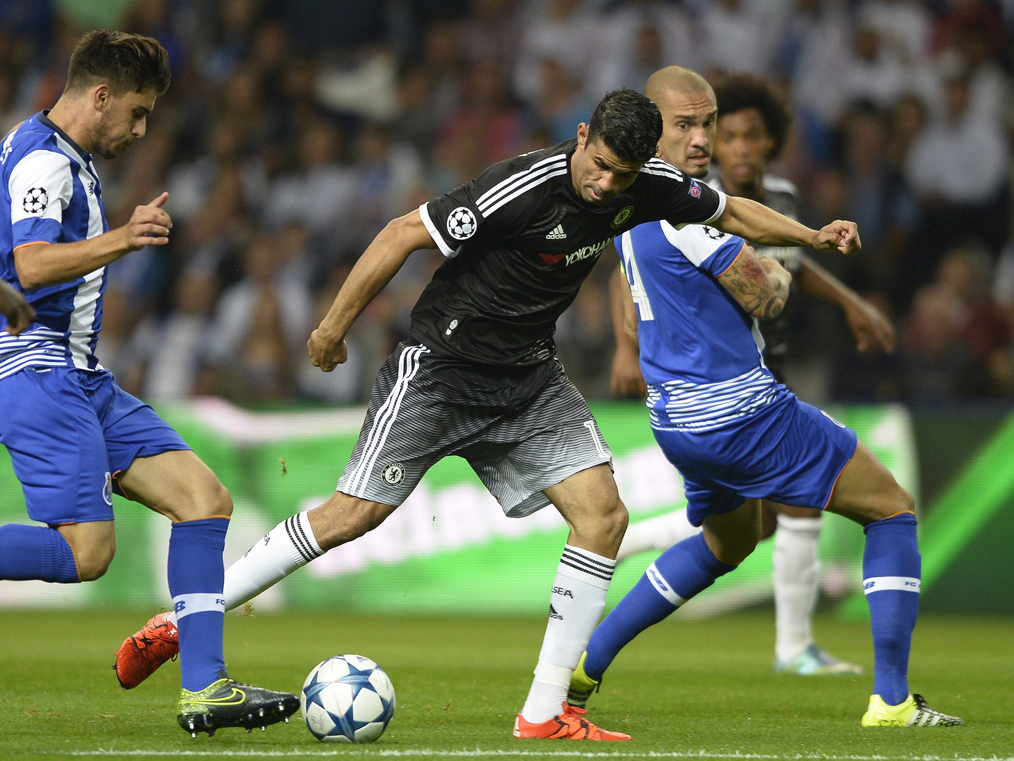 Diego Costa jostles for the ball with Ruben Neves and Maicon