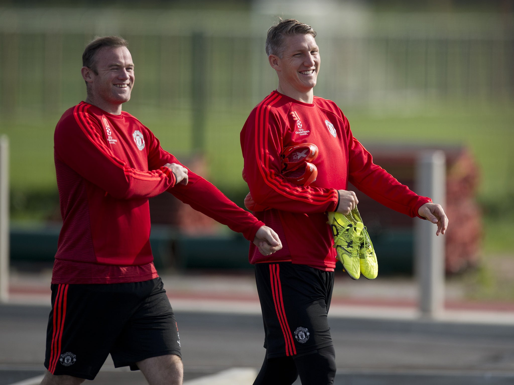 Wayne Rooney and Bastian Schweinsteiger share a joke during training