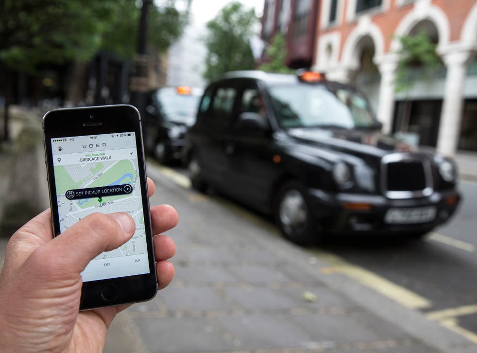 A smartphone displays the 'Uber' mobile application which allows users to hail private-hire cars from any location