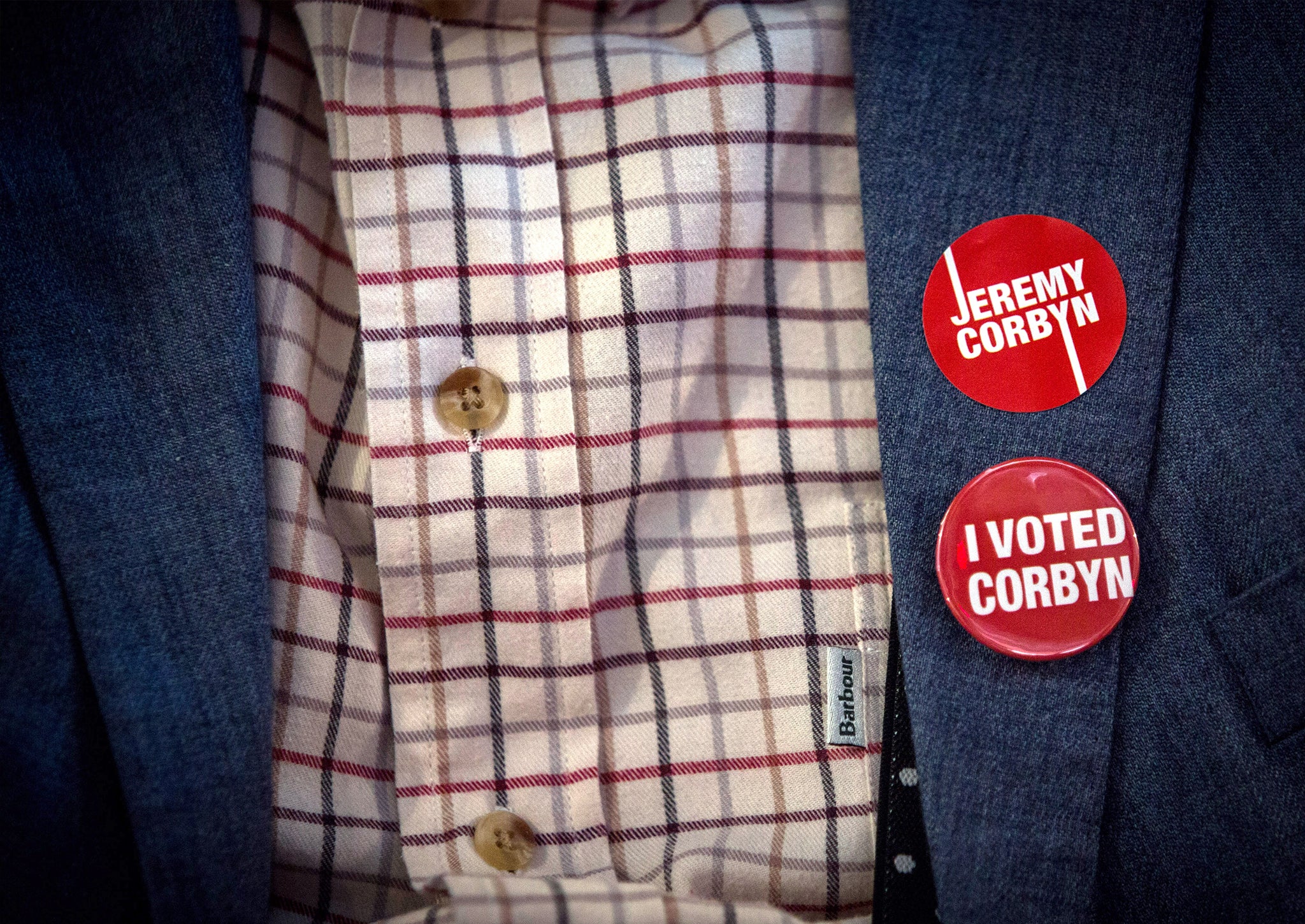 A supporter of Jeremy Corbyn, MP for Islington North and candidate in the Labour Party leadership election, wears badges on a jacket during speaches at the Rock Tower on September 10, 2015