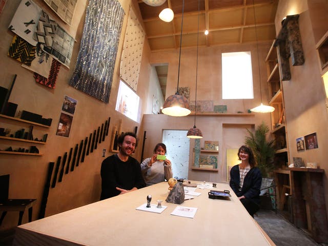 Lewis Jones, Amica Dall and Fran Edgerley, members of the Turner Prize nominated Assemble collective, sit inside their exhibit at Tramway in Glasgow