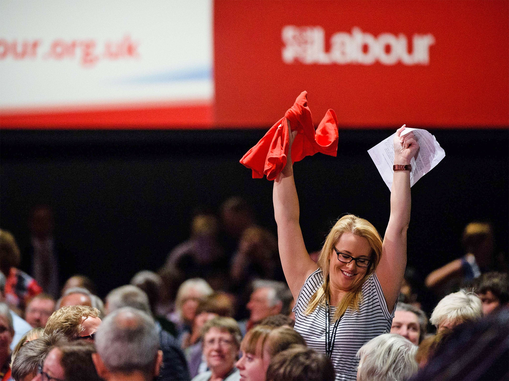 A Labour delegate celebrates after being chosen to address the audience