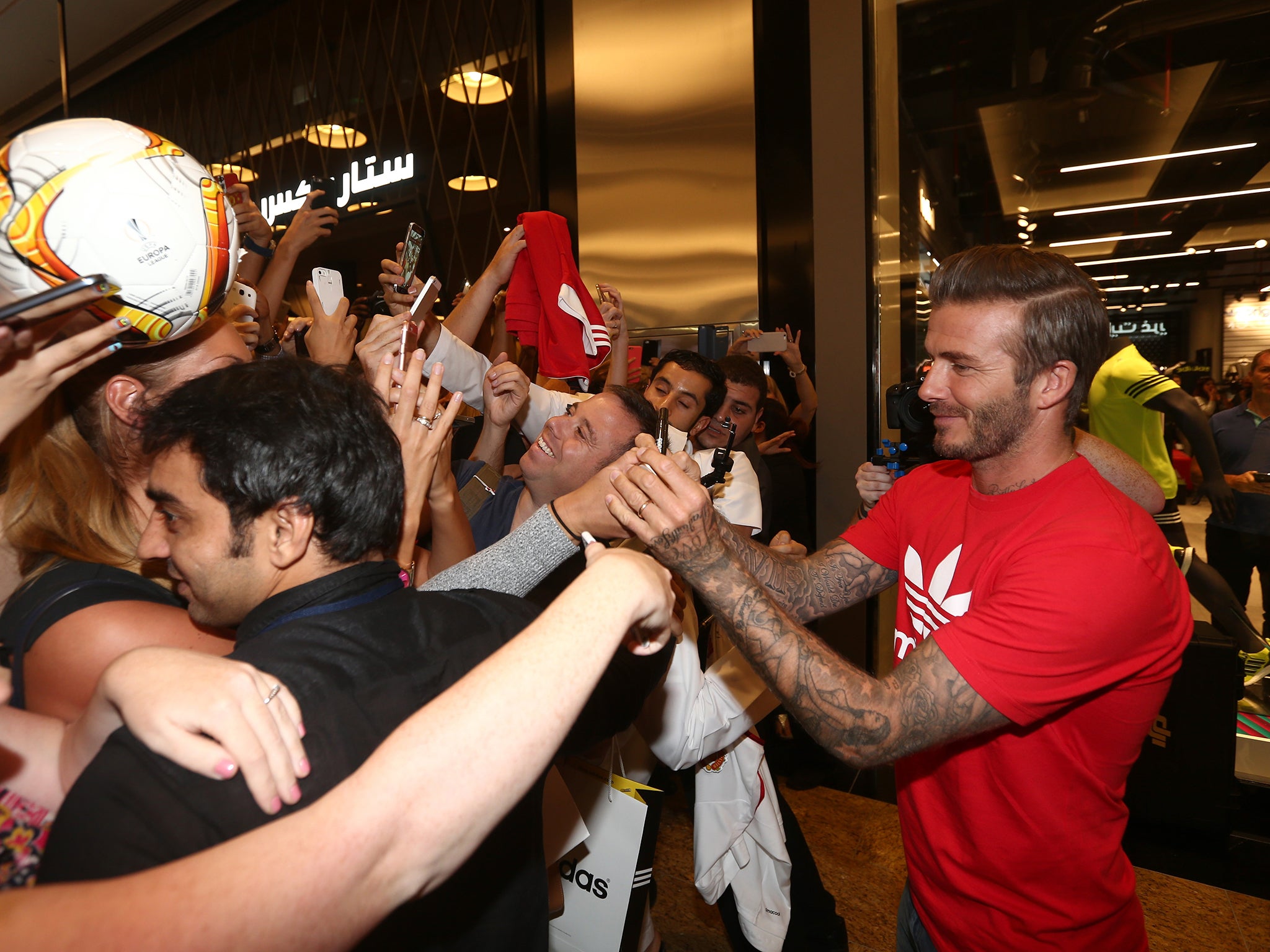 Beckham signs autographs at the store opening in Dubai